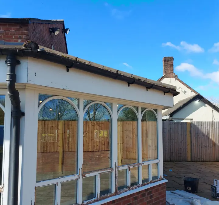 Weathered exterior timber window elevation before decoration